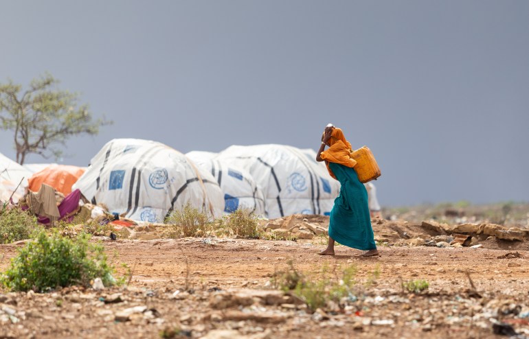 Badidoa, Somali May 15, 2019: Women carrying clean water on their heads in a refugee camp in Africa