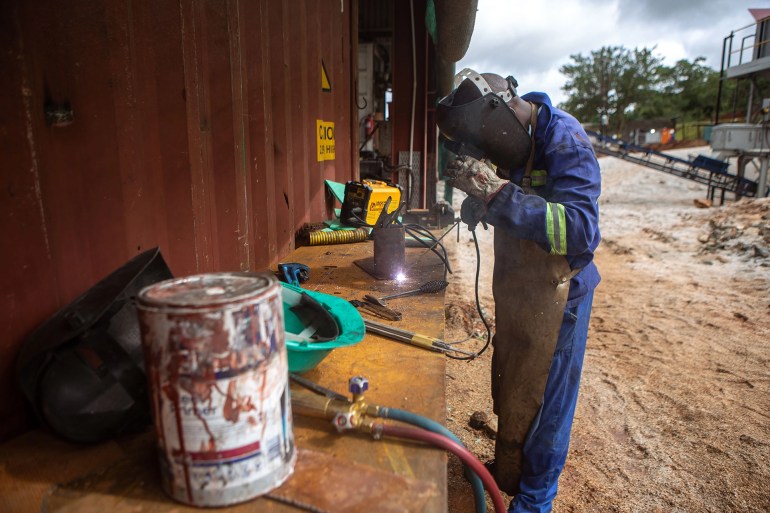 A welder works on some stills before heading into the warehouse for repairs at Arcadia lithium mine [File: Tafadzwa Ufumeli/Getty Images]