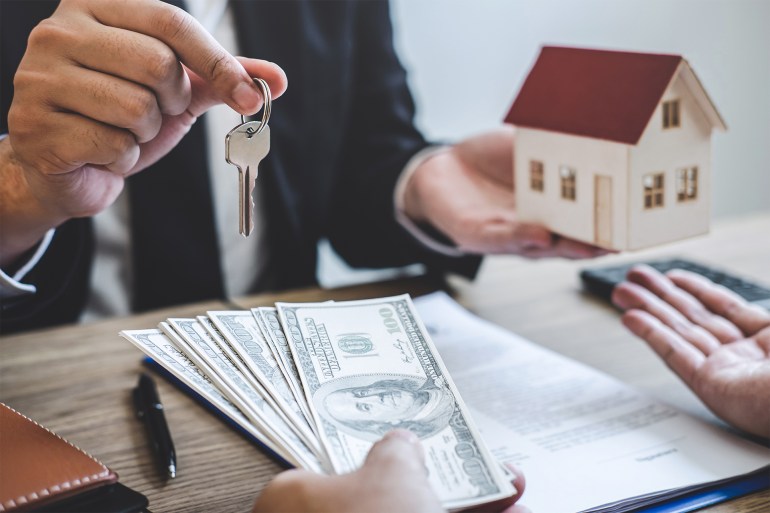 Real Estate agent broker receive money from client after signing agreement contract real estate with approved mortgage application form, buying or concerning mortgage loan offer for and house insurance.