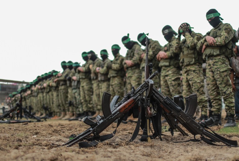 KHAN YUNIS, GAZA - DECEMBER 5: Izz ad-Din al-Qassam Brigades, military wing of the Palestinian Hamas, perform prayer as they attend a military parade during the 30th anniversary of the foundation of Hamas in Khan Yunis, Gaza on December 5, 2017. (Photo by Ali Jadallah/Anadolu Agency/Getty Images)