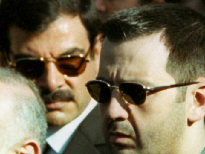 (FILES) A file picture dated June 13, 2000, shows General Assef Shawkat (L), then head of Syrian military intelligence and current deputy defence minister, with Maher Al-Assad (R), brother of President Bashar al-Assad, during the funeral of late president Hafez al-Assad in Damascus. Shawkat, Bashar and Maher's brother-in-law, was killed in a suicide attack targeting a meeting of top security chiefs in Damascus on July 18, 2012, Syrian state TV said.