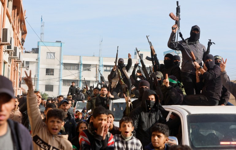 Palestinian militants celebrate despite a delay in the ceasefire between Israel and Hamas over the hostage list, in Khan Younis in the southern Gaza Strip, January 19, 2025. REUTERS/Mohammed Salem