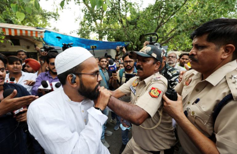 Police officials try to detain members and supporters of AISA during protest against what they say attacks on Muslims following clashes on June 13, 2022 triggered by remarks made by ruling BJP figures on Prophet Mohammad, at Jantar Mantar, in New Delhi. (REUTERS)