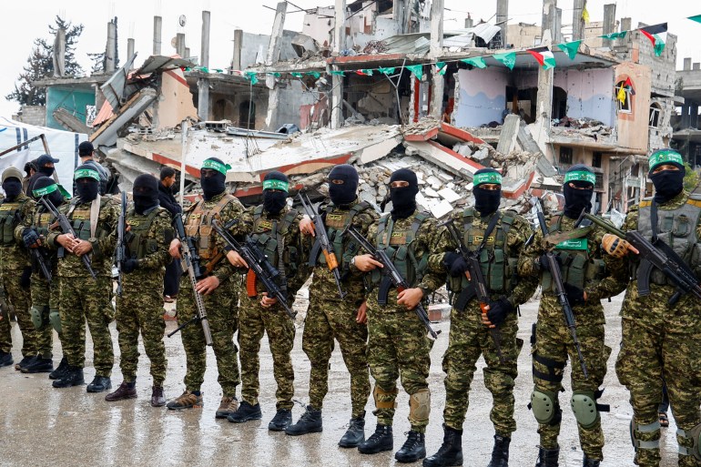 Palestinian Hamas militants stand guard on the day of the handover of hostages held in Gaza since the deadly October 7 2023 attack, as part of a ceasefire and a hostages-prisoners swap deal between Hamas and Israel, in Rafah in the southern Gaza Strip, February 22, 2025. REUTERS/Hatem Khaled