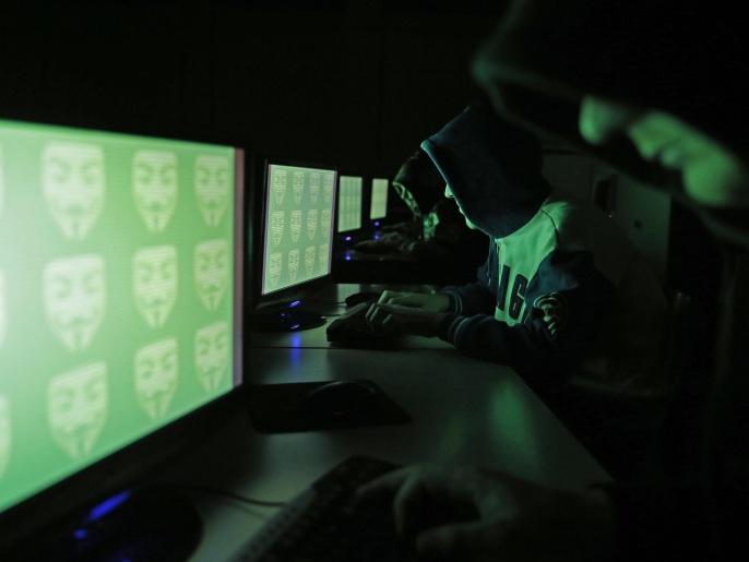 People pose in front of a display showing the word 'cyber' in binary code, in this picture illustration taken in Zenica December 27, 2014. A previously undisclosed hacking campaign against military targets in Israel and Europe is probably backed by a country that misused security-testing software to cover its tracks and enhance its capability, researchers said. Picture taken December 27, 2014. REUTERS/Dado Ruvic (BOSNIA AND HERZEGOVINA - Tags: SCIENCE TECHNOLOGY CRIME LAW)