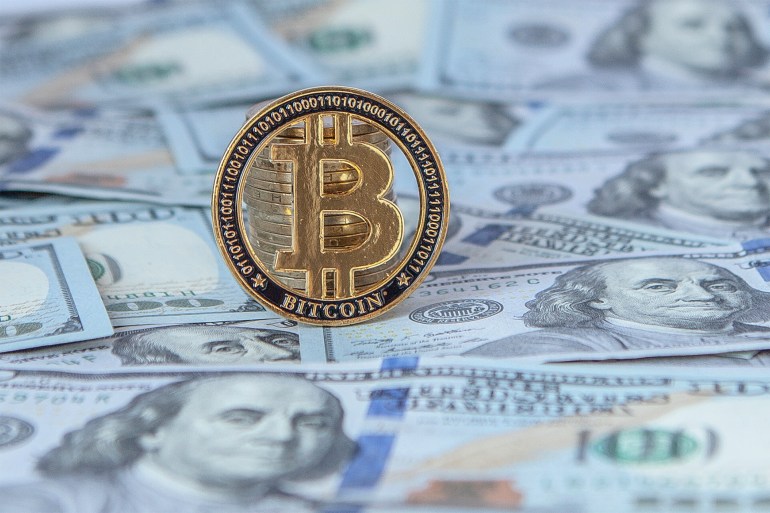 Bitcoin against the background of dollar bills. exchange bitcoin for dollars. fall of bitcoin.