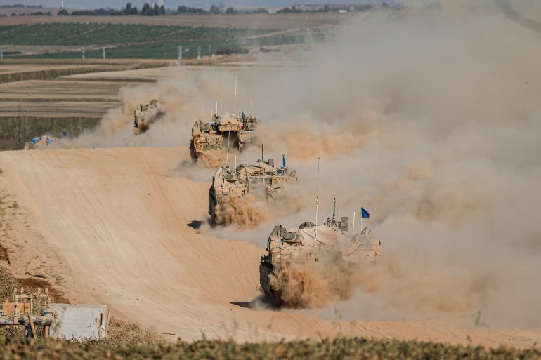 RAFAH, GAZA, ISRAEL - 2024/05/29: Israeli tanks operate, amid the ongoing conflict between Israel and the Palestinian Islamist group Hamas. The movement of tanks, armored personnel carriers, trucks, and military jeeps belonging to the Israeli army continues along the border near Rafah, Gaza. At least 45 people, mostly women and children, were killed, and nearly 250 others were injured in an Israeli strike on the camp on Sunday. (Photo by Saeed Qaq/SOPA Images/LightRocket via Getty Images)