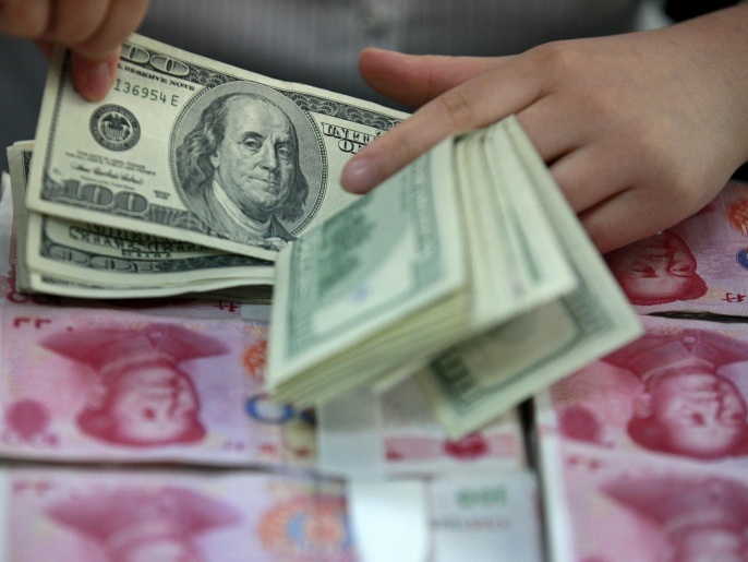 A bank clerk counts U.S. dollar banknotes on bundles of 100 Chinese yuan banknotes at a branch of a bank in Huaibei, Anhui province in this April 26, 2012 file photo. China's banking regulator and main bond clearinghouse have asked commercial banks to reduce rates they offer on high-yielding wealth management products (WMPs), five sources told Reuters, an apparent back-pedalling on commitments to let markets price credit. REUTERS/Stringer/FilesCHINA OUT. NO COMMERCIAL OR EDITORIAL SALES IN CHINA