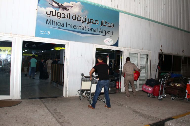 TRIPOLI, LIBYA - JULY 22: Passengers queues to drop their bags off as they check-in for their flights at the Mitiga International Airport in Tripoli, Libya on July 22, 2014. Following the clashes, Mitiga Airport opens for domestic and foreign flights. (Photo by Hazem Turkia/Anadolu Agency/Getty Images)
