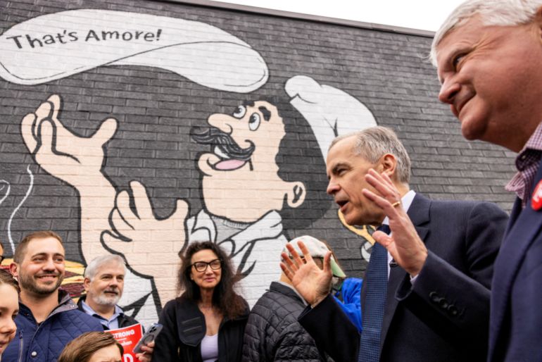 Canada's Prime Minister Mark Carney greets supporters at Aurora's Restraurant with local candidate Terry Sheehan during his Liberal Party election campaign tour in Sault Ste. Marie, Ontario, Canada April 25, 2025. REUTERS/Carlos Osorio