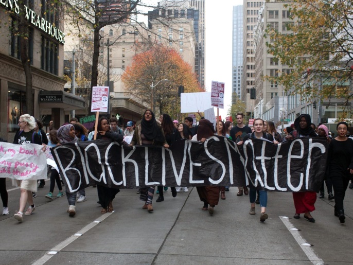 epaselect epa05631769 Protesters march through downtown streets during a protest in Seattle, Washington, USA, 14 November 2016. Banner reading 'Black Lives Matter.' Students across the city left class early to voice their opposition to the recently elected President of the United States.