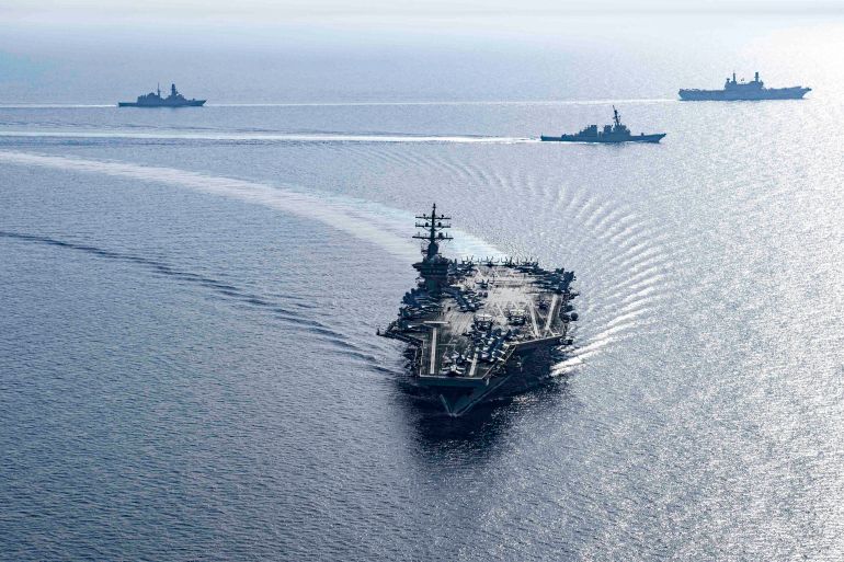 This handout photo released by the US Defence Visual Information Distribution Service (DVIDS) shows the US Navy Nimitz-class aircraft carrier USS Dwight D. Eisenhower (CVN 69) and Arleigh Burke-class guided-missile destroyers USS Laboon (DDG 58) and USS Gravely (DDG 107), part of the Dwight D. Eisenhower Carrier Group (IKECSG), sailing in formation in the Red Sea with the Italian aircraft carrier ITS Cavour (CVH 550) on June 7, 2024, as part of their mission to support maritime stability and security in the Middle East region. (Photo by DVIDS / AFP) / RESTRICTED TO EDITORIAL USE - MANDATORY CREDIT "AFP PHOTO / US NAVY " - NO MARKETING NO ADVERTISING CAMPAIGNS - DISTRIBUTED AS A SERVICE TO CLIENTS