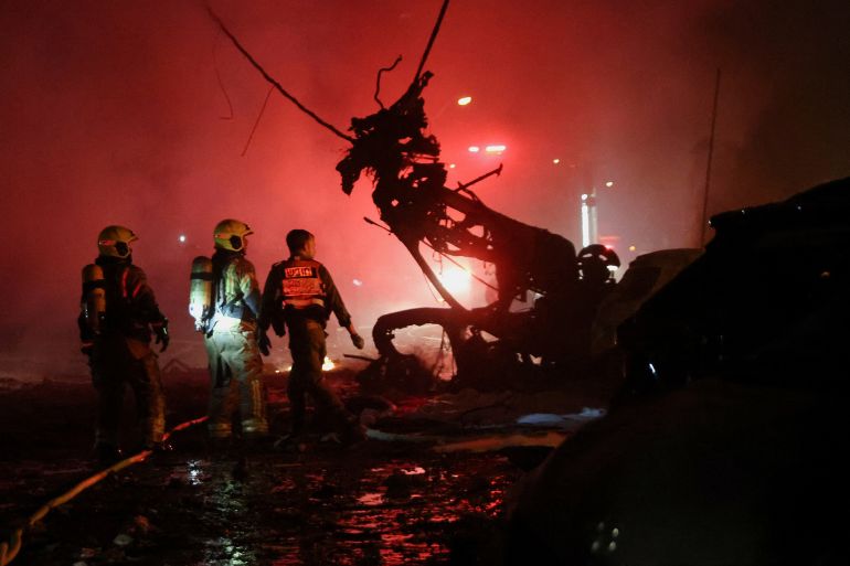 Emergency personnel operate after missiles were launched from Iran to Israel, in Haifa, Israel, June 15, 2025. REUTERS/Shir Torem