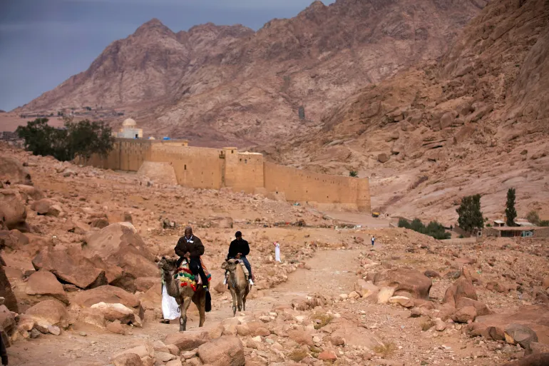 FILE - Visitors leave Saint Catherine's Monastery in Saint Catherine, Egypt, Dec. 9, 2013. (AP Photo/Hiro Komae, File)