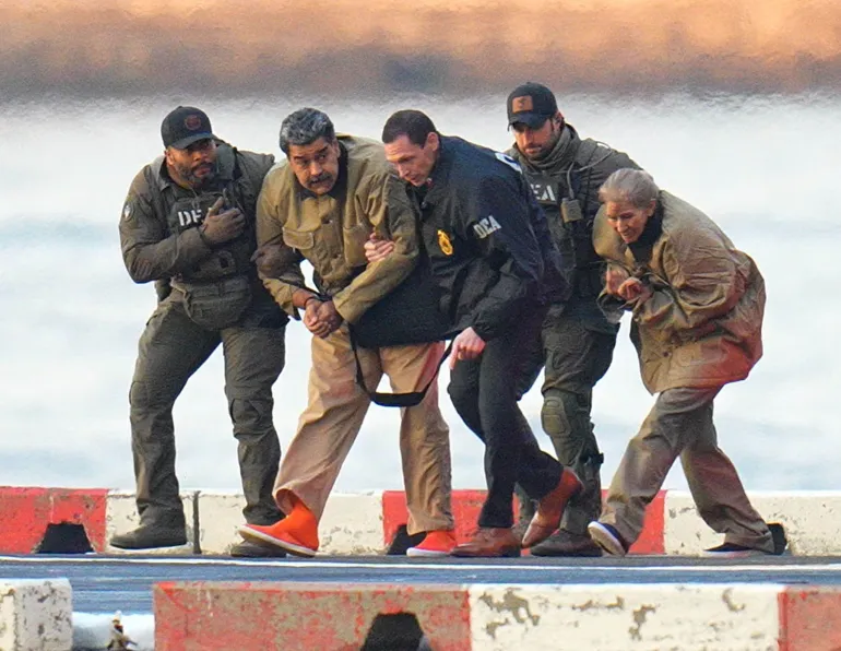 NEW YORK, NY - JANUARY 5: Nicolas Maduro and his wife, Cilia Flores, are seen in handcuffs after landing at a Manhattan helipad, escorted by heavily armed Federal agents as they make their way into an armored car en route to a Federal courthouse in Manhattan on January 5, 2026 in New York City. (Photo by XNY/Star Max/GC Images)