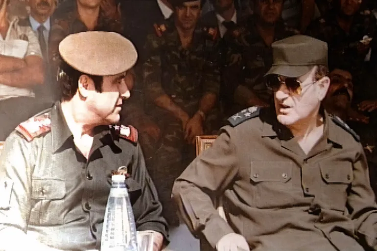 Picture taken in 1984 shows late Syrian president Hafez al-Assad (R) with his youngest brother Rifaat (L) at a military ceremony in Damascus. The estranged and banished brother, Rifaat, announced 12 June 2000 that he considers himself the legitimate successor to the presidency of Syria. The statement represents a direct challenge to the right of Bashar al-Assad, the late president's son and designated heir, to take the post. (Photo by Handout / AFP) / XGTY / == RESTRICTED TO EDITORIAL USE - MANDATORY CREDIT "AFP PHOTO / HO " - NO MARKETING NO ADVERTISING CAMPAIGNS - DISTRIBUTED AS A SERVICE TO CLIENTS == - XGTY / == RESTRICTED TO EDITORIAL USE - MANDATORY CREDIT "AFP PHOTO / HO " - NO MARKETING NO ADVERTISING CAMPAIGNS - DISTRIBUTED AS A SERVICE TO CLIENTS == / BEST QUALITY AVAILABLE