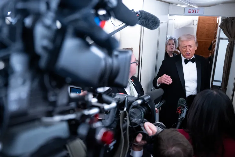 US President Donald Trump speaks to members of the media aboard Air Force One as he travels from Washington, DC to West Palm Beach, Florida, on January 31, 2026.