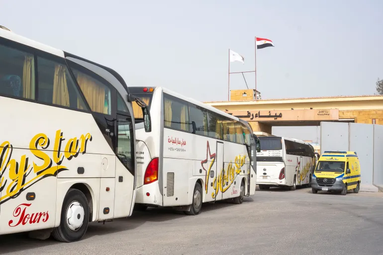 Buses line up to enter the Egyptian gate of the Rafah crossing into the Gaza Strip, in Rafah, Egypt, Monday, Feb. 2, 2026. (AP Photo/Mohamed Arafat)