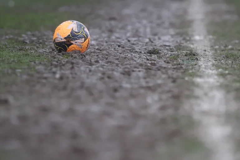 GRIMSBY, ENGLAND - FEBRUARY 15: A detailed view of the Mitre FA Cup match ball on the muddy sideline during the Emirates FA Cup Fourth Round match between Grimsby Town and Wolverhampton Wanderers on February 15, 2026 in Grimsby, England. (Photo by Nigel Roddis/Getty Images)
