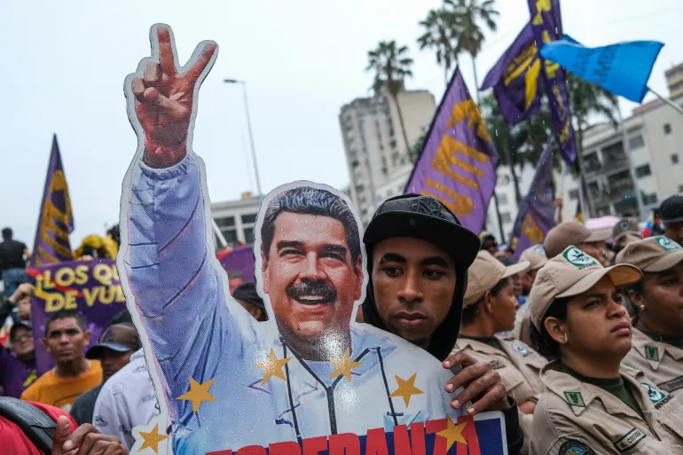 A man holds a cutout of ousted President Nicolas Maduro, as supporters of Venezuela's government rally to demand the release of Maduro and his wife Cilia Flores, following their capture by U.S. forces during recent U.S. strikes on the country, in Caracas, Venezuela, January 23, 2026. REUTERS/Marco Bello