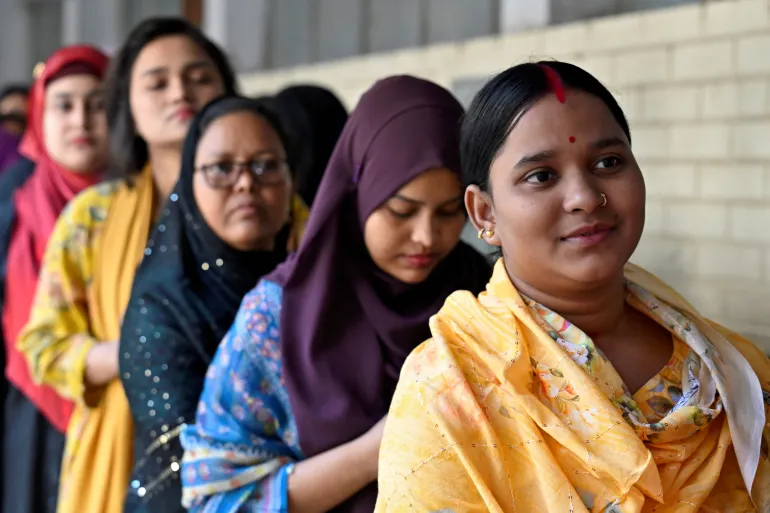 Women stand in a queue to vote outside a polling station during the national election in Dhaka, Bangladesh, February 12, 2026. REUTERS/Fatima Tuj Johora