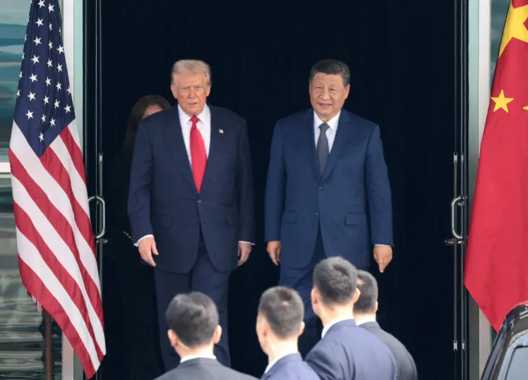 FILE PHOTO: U.S. President Donald Trump and Chinese President Xi Jinping walk as they leave after a bilateral meeting at Gimhae International Airport, on the sidelines of the Asia-Pacific Economic Cooperation (APEC) summit, in Busan, South Korea, October 30, 2025. REUTERS/Evelyn Hockstein/File Photo