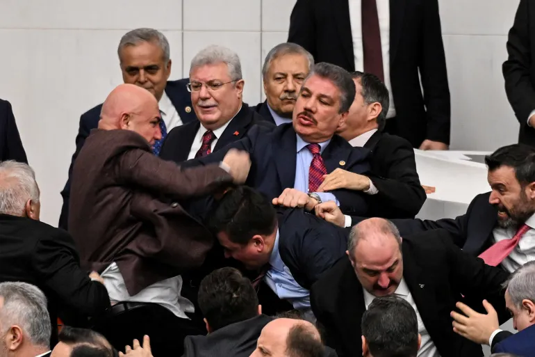 Lawmakers from the main opposition Republican People’s Party (CHP) scuffle with members of the ruling AK Party during a protest over newly appointed Justice Minister Akin Gurlek (not pictured), at the Parliament in Ankara, Turkey, February 11, 2026. REUTERS/Stringer TURKEY OUT. NO COMMERCIAL OR EDITORIAL SALES IN TURKEY.