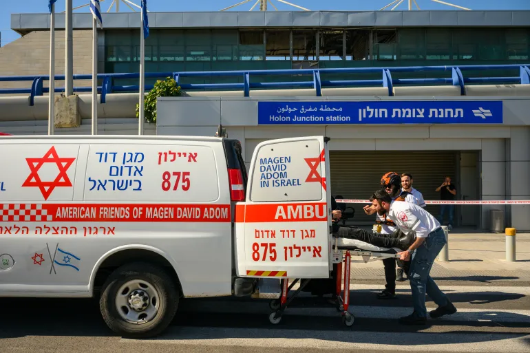 HOLON, ISRAEL - MARCH 17: Magen David Adom first responders treat a person near where an Iranian missile was intercepted on March 17, 2026 in Holon, Israel. The person needed medical attention but was not struck by missile debris, which damaged the nearby train station. Iran has continued firing waves of drones and missiles at Israel after the United States and Israel launched a joint attack on Iran early on February 28th. (Photo by Alexi J. Rosenfeld/Getty Images)