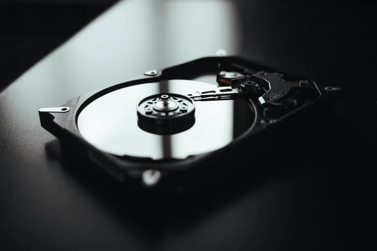 Opened hard drive from the computer hdd with mirror effects. Part of computer pc, laptopDisassembled hard drive from the computer, hdd with mirror effect. Opened hard drive from the computer hdd with mirror effects. Part of computer pc, laptop