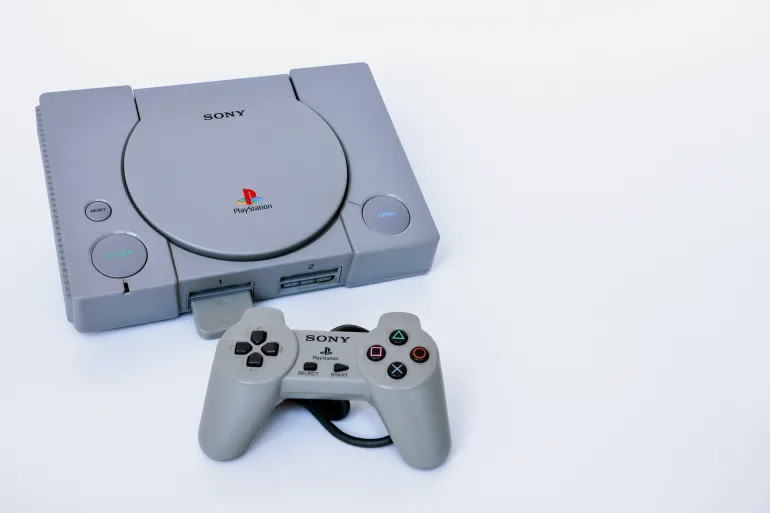 Bangkok, Thailand - February 28, 2021 : The original model of Playstation 1 gaming console with wired PS1 controller.