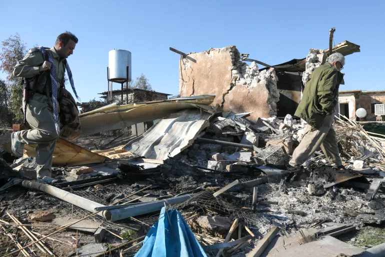 An Iranian Kurdish Peshmerga member of the Kurdistan Democratic Party of Iran (KDPI) inspects damage sustained at the Azadi Camp of the Kurdistan Democratic Party of Iran (KDPI) following an Iranian cross-border attack in the town of Koye (Koysinjaq), in the east of Erbil district in the autonomous Kurdish region of northern Iraq on March 3, 2026.