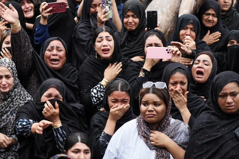 In this picture obtained from Iran's ISNA news agency, mourners cry during the funeral of children killed in a reported strike on a primary school in Iran’s Hormozgan province, in Minab on March 3, 2026.