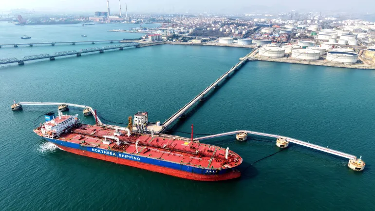 An oil tanker unloads crude oil at a terminal at the port in Qingdao, in China’s eastern Shandong province on March 10, 2026. (Photo by CN-STR / AFP) / CHINA OUT