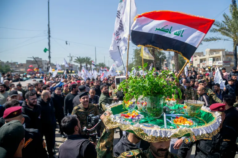 Mourners march in the funeral of Hussein Fadhel Ali, a member of Iraq's Hashed al-Shaabi alliance now integrated into the regular army but which also includes brigades belonging to Iran-backed groups, who was killed in a strike earlier in the week, in Baghdad's Sadr City suburb on March 24, 2026.