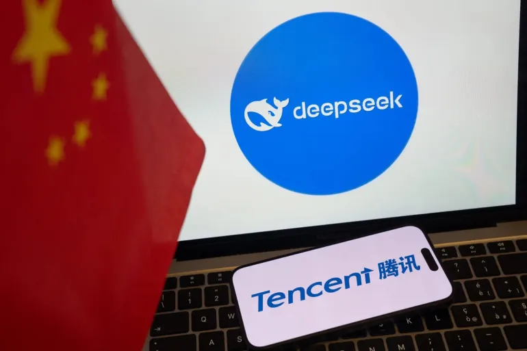 The logos for the DeepSeek AI service, top, and Tencent Holdings Ltd. next to a Chinese flag arranged in Beijing, China, on Monday, Feb. 17, 2025. Optimism over AI's potential has sparked a blistering rally in China's stock market over the past month, turning the Hang Seng China Enterprises Index into the world's best-performer. Photographer: Andrea Verdelli/Bloomberg via Getty Images