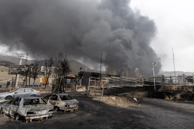 TEHRAN, IRAN - MARCH 8: Remains of burnt cars as smoke billows after overnight airstrikes on oil depots on March 8, 2026 in Tehran, Iran. The United States and Israel continued their joint attack on Iran that began on February 28. Iran retaliated by firing waves of missiles and drones at Israel, and targeting U.S. allies in the region. (Photo by Majid Saeedi/Getty Images)