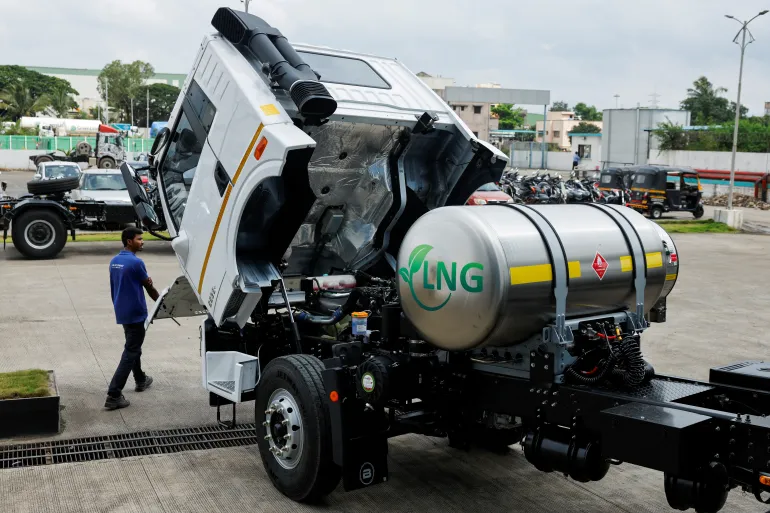 FILE PHOTO: A man opens the hood of a Blue Energy 5528 liquefied natural gas (LNG) truck to check the engine at the manufacturing facility in Pune, India, October 11, 2024. REUTERS/Francis Mascarenhas/File Photo
