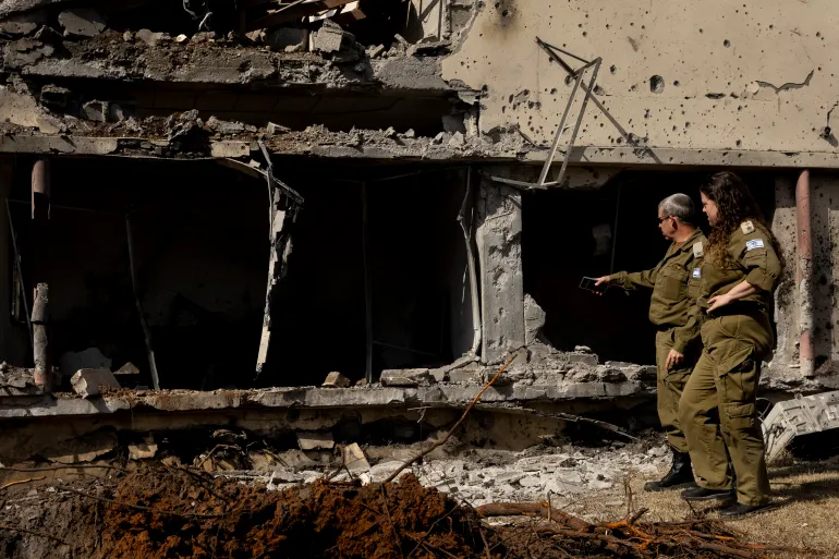 HANI'EL, ISRAEL - MARCH 12: Israeli rescue and emergency soldiers look at the impact of a missile strike, after Hezbollah, and Iran launched a coordinated barrages on northern and central Israel on March 12, 2026 in Hani'el, Israel. Iran has continued firing waves of drones and missiles at Israel after the United States and Israel launched a joint attack on Iran early on February 28th. (Photo by Amir Levy/Getty Images)