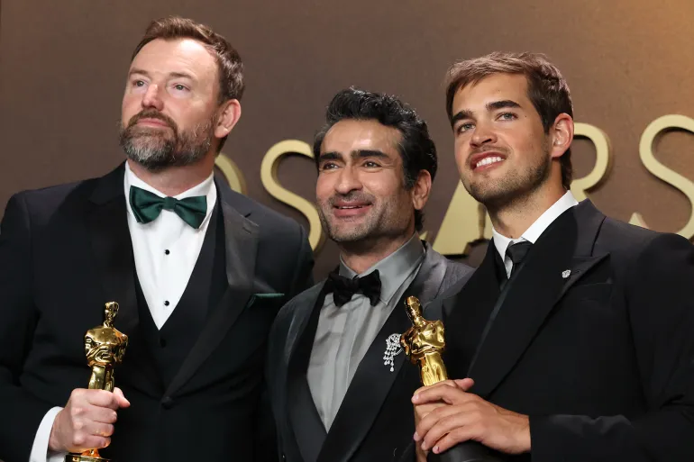 Hollywood, CA - March 15, 2026: Jack Piatt, left and Sam A. Davis, right, winners of the Live Action Short Film award for "The Singers", pose with Kumail Nanjiani, center, in the press room during the 98th Annual Academy Awards held by the Academy of Motion Picture Arts and Sciences at the Dolby Theatre in Hollywood, CA, Sunday, March 15, 2026. (Kayla Bartkowski / Los Angeles Times via Getty Images)