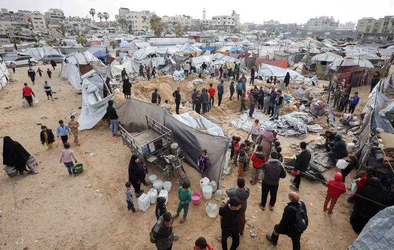 Palestinians inspect the site of Wednesday’s Israeli strike on a tent camp sheltering displaced Palestinians, in Gaza City, March 12, 2026. The Israeli military ordered the camp to evacuate before the strike. REUTERS/Dawoud Abu Alkas TPX IMAGES OF THE DAY
