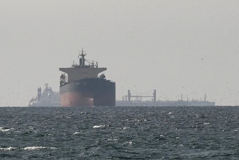 FILE PHOTO: Cargo ships in the Gulf, near the Strait of Hormuz, as seen from northern Ras al-Khaimah, near the border with Oman’s Musandam governance, amid the U.S.-Israeli conflict with Iran, in United Arab Emirates, March 11, 2026. REUTERS/Stringer/File Photo REFILE - CORRECTING "TANKERS" TO "CARGO SHIPS" AND REMOVING ACTION "SAIL".