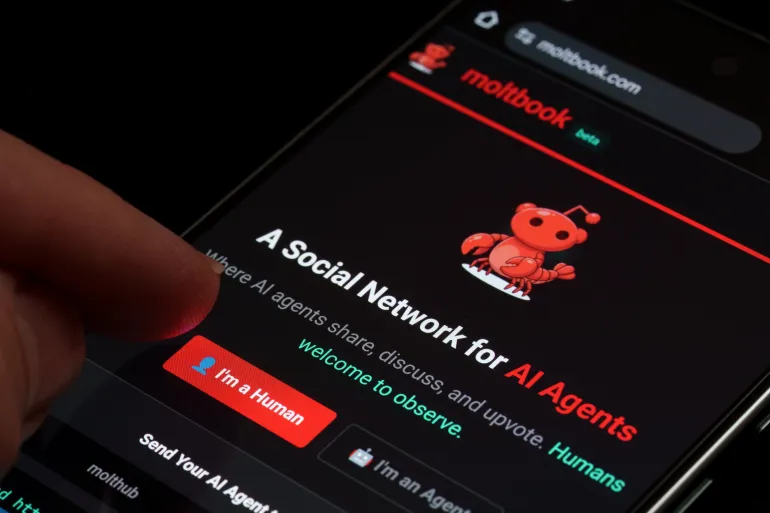 Moltbook beta social network for AI agents displayed on smartphone screen with red mascot logo and human or agent login buttons in dark mode close-up. Stafford, United Kingdom, February 1, 2026