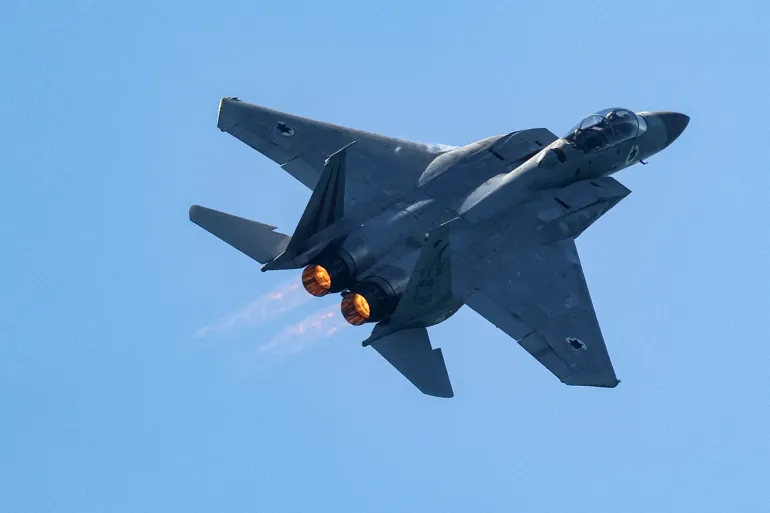 (FILES) An Israeli Air Force F-15E Strike Eagle fighter aircraft flies over during an air show in Tel Aviv on April 26, 2023, as Israel marks Independence Day (Yom HaAtzmaut), 75 years since the establishment of the Jewish state.