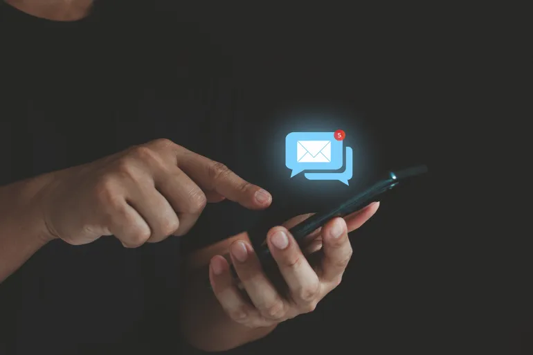 Business email communication and digital marketing technology. Stay connected with e-mail notifications! A businessman checks his inbox on his phone, keeping up with work and life on the go.
