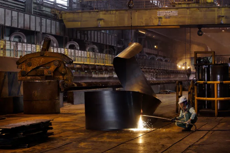 FILE - In this May 31, 2012 file photo, an Iranian worker cuts a steel roll at the Mobarakeh Steel Complex, some 280 miles (460 kilometers) south of the capital Tehran, and some 40 miles, 65 kilometers, southwest of central Iranian city of Isfahan. President Donald Trump ordered new sanctions on Iran Wednesday targeting Iran's steel, aluminum, copper and iron sectors, which provide foreign currency earnings for the nation's sagging economy. (AP Photo/Vahid Salemi, File)