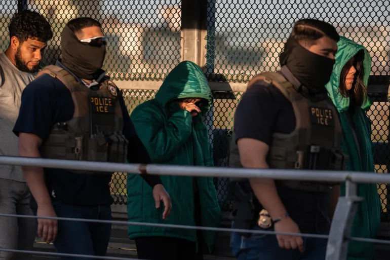 FILE - A group of undocumented migrants are deported by U.S. Immigration and Customs Enforcement agents across the McAllen–Hidalgo–Reynosa International Bridge in McAllen, Texas, March 13, 2026. (AP Photo/Felix Marquez)
