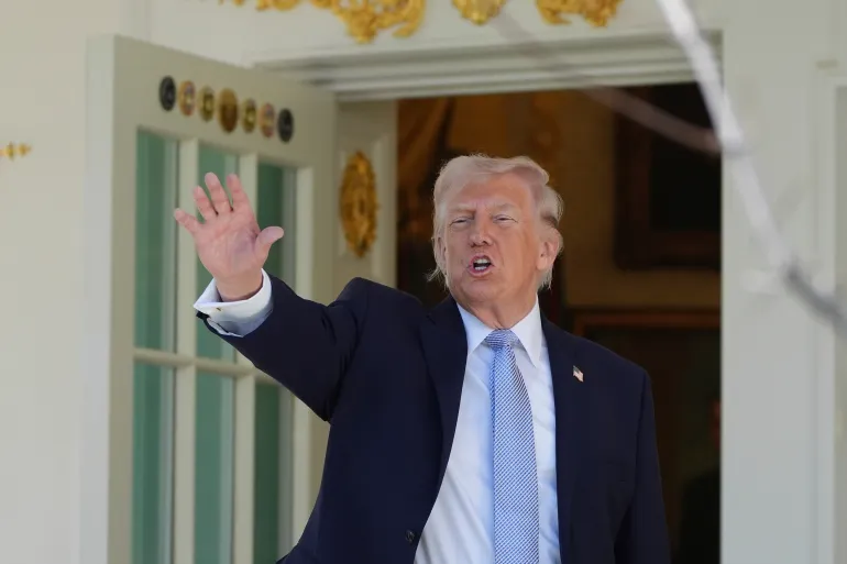 President Donald Trump gestures as he prepares to head back to the Oval Office after participating in the White House Easter Egg Roll on the South Lawn of the White House, Monday, April 6, 2026, in Washington. (AP Photo/Alex Brandon)