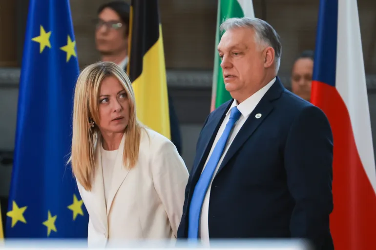 epa12833048 Italian Prime Minister Giorgia Meloni (L) and Hungarian Prime Minister Viktor Orban (R) prepare for a family picture during a formal meeting of the members of the European Council in Brussels, Belgium, 19 March 2026. Leaders are expected to discuss the situation in the Middle East and Iran, continued support for Ukraine, European competitiveness, defence readiness and migration amid rising geopolitical and economic tensions. EPA/OLIVIER HOSLET