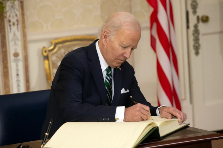 DUBLIN, IRELAND - APRIL 13: In this handout image provided by the Irish Government, US President Joe Biden signs the visitors book at the Irish President's official residence Áras an Uachtaráin on April 13, 2023 in Dublin, Ireland. US President Joe Biden has travelled to Northern Ireland and Ireland with his sister Valerie Biden Owens and son Hunter Biden to explore his family's Irish heritage and mark the 25th Anniversary of the Good Friday Peace Agreement. (Photo by Julien Behal/Irish Government via Getty Images)