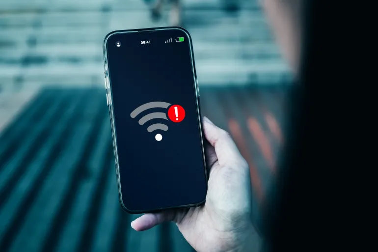 Smartphone screen displays notification of connection problems or no Wi-Fi signal. Concepts of technological, wireless network connections, security cyber, and encryption.